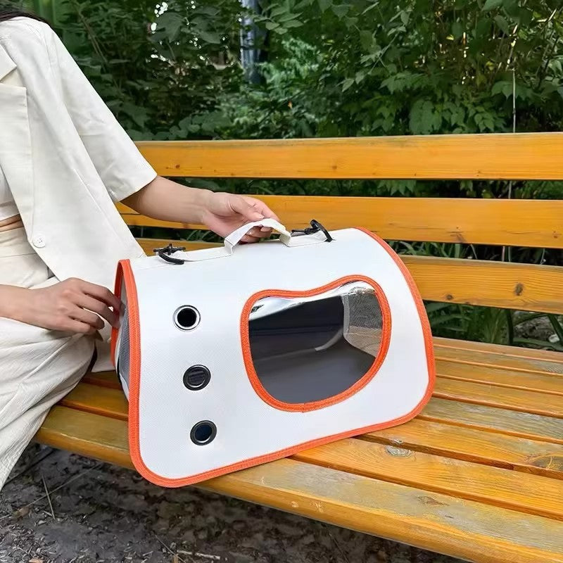 Pet carrier backpack with clear bubble window, white with orange trim, side handle strap