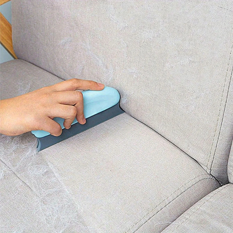 Light blue pet hair remover brush with gray ridged edge