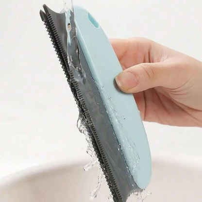 Light blue brush with gray ridged side, hair clinging to teeth