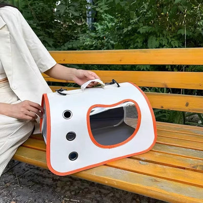 Pet carrier backpack with clear bubble window, white with orange trim, side handle strap