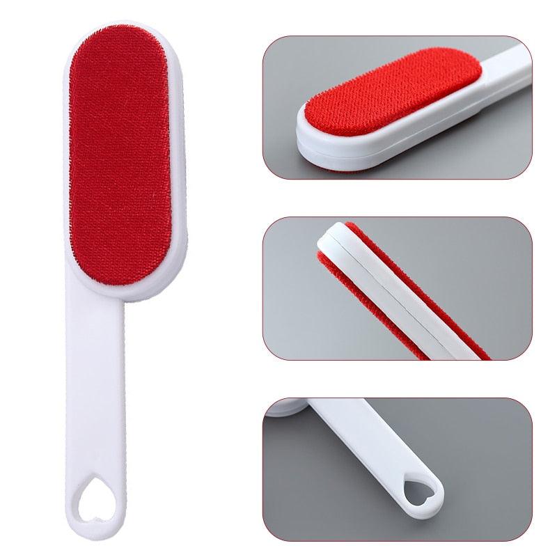 Reusable pet hair remover brush with red pad and white handle with self-cleaning base