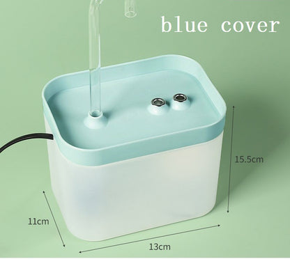 Automatic cat water fountain with blue cover, clear spout, and two intake ports